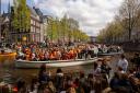 People dance on a boat during King’s Day celebrations in Amsterdam on Saturday (Peter Dejong/AP)