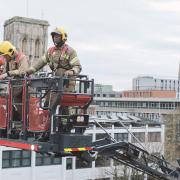 Stock image of Avon firefighters on an aerial ladder platform