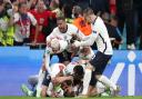 England's Harry Kane is mobbed by team-mates after scoring their side's second goal of the game in extra-time during the UEFA Euro 2020 semi final match at Wembley Stadium, London. Picture date: Wednesday July 7, 2021.