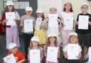 Children holding Mini Medic certificates