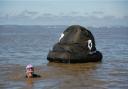 Mermaid Lindsey towed an inflatable poo during her swim across the channel to raise awareness of sewage pollution