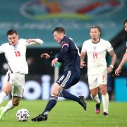 England's Mason Mount (left) and Scotland's Callum McGregor battle for the ball during the UEFA Euro 2020 Group D match at Wembley Stadium, London. Picture date: Friday June 18, 2021.