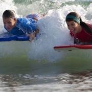 Two Girls doing surf in the beach