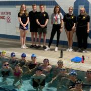 Paralympian Gold medallists Lauren Steadman with young volunteers at Clevedon Swimming Club.