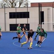 Lucy Pratt of Clevedon (yellow socks) takes the ball into the heart of the home defence.
