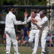 Clevedon CC's Mark Bibbing (centre) took two wickets for 31 runs against Downend.