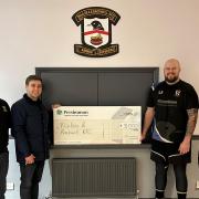 Members of the club presented with the cheque
